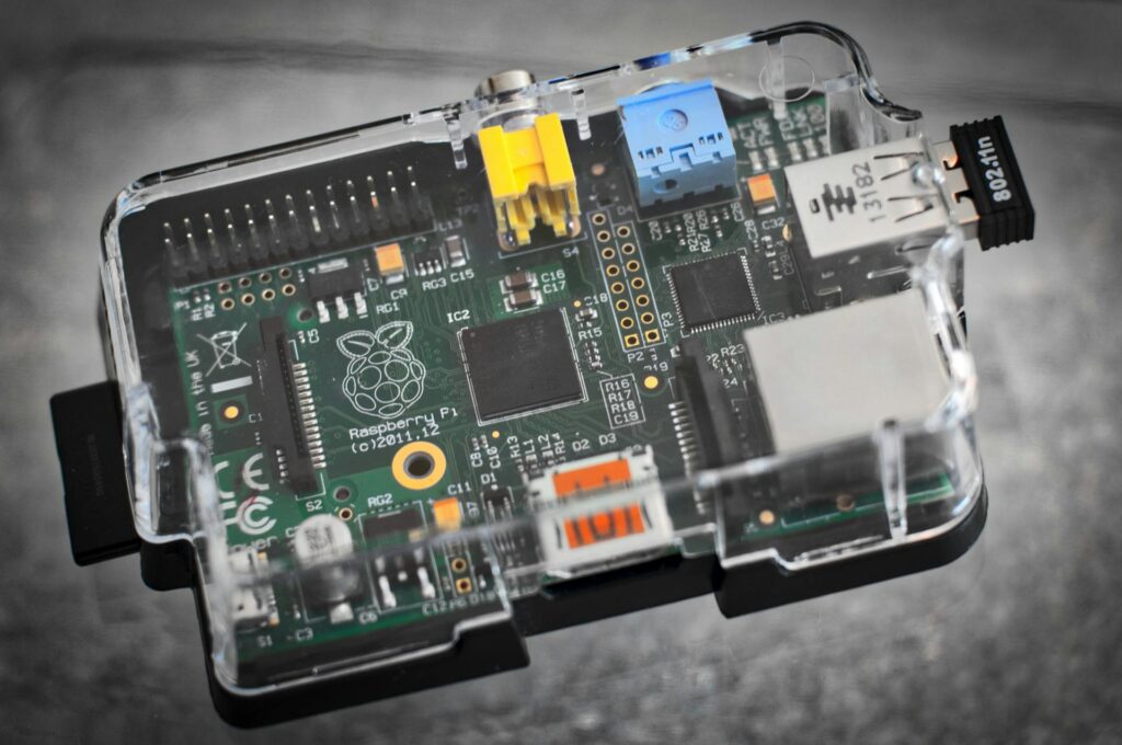 Detailed image of a Raspberry Pi microcomputer circuit board in a clear case.